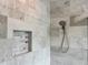 Elegant shower with marble tile walls, niche, and dual shower head offers a spa-like experience at 8263 Bellow St, Orlando, FL 32827