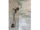 Bathroom featuring shower with dual showerhead and marble-look tiling, creating a luxurious space at 8263 Bellow St, Orlando, FL 32827