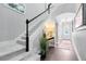 Staircase and entryway featuring neutral paint, carpeted stairs, and modern decor at 8263 Bellow St, Orlando, FL 32827