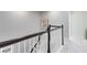Neutral stairway with wood railing, white spindles and carpeted steps with beach themed art at 8263 Bellow St, Orlando, FL 32827