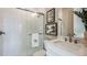 This modern bathroom boasts a glass-enclosed shower, tiled walls, and quartz countertops at 857 Junonia Blvd, New Smyrna Beach, FL 32168