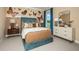 Stylish bedroom with butterfly decor, a cozy bed, and ample natural light from the large window at 857 Junonia Blvd, New Smyrna Beach, FL 32168