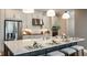 Modern kitchen featuring stainless steel appliances, a large island with seating, and stylish pendant lighting at 857 Junonia Blvd, New Smyrna Beach, FL 32168