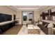 Cozy living room features a work station, lots of natural light, and comfortable furniture at 857 Junonia Blvd, New Smyrna Beach, FL 32168