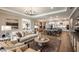 Bright living room boasts hardwood floors and open floor plan that leads to the kitchen and dining area at 857 Junonia Blvd, New Smyrna Beach, FL 32168