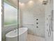 Modern bathroom featuring a freestanding tub, walk-in shower, and stylish fixtures at 9364 Thurloe Pl, Orlando, FL 32827