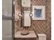 Stylish powder room featuring unique sink, chic fixtures, and herringbone wall tile at 9364 Thurloe Pl, Orlando, FL 32827