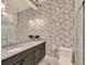 Well-lit bathroom with unique wallpaper and a modern vanity at 9364 Thurloe Pl, Orlando, FL 32827