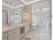 Spa-like bathroom with double vanity, walk-in shower, and soaking tub for ultimate relaxation at 9364 Thurloe Pl, Orlando, FL 32827