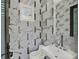 Elegant bathroom featuring decorative marble walls, modern fixtures, and stylish design at 9364 Thurloe Pl, Orlando, FL 32827