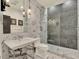 Modern bathroom with marble walls, stylish fixtures, and a glass-enclosed shower at 9364 Thurloe Pl, Orlando, FL 32827