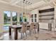 Dining room area with dining table, chairs, and view of outdoor pool through glass doors at 9364 Thurloe Pl, Orlando, FL 32827
