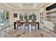 Dining room with dark wood table, fabric chairs, and French doors leading to outdoor pool at 9364 Thurloe Pl, Orlando, FL 32827