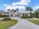 Gorgeous home featuring a circular driveway, mature landscaping, and a three-car garage at 9364 Thurloe Pl, Orlando, FL 32827