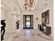 Spacious foyer features marble flooring, modern lighting, art display, and a view to the outdoors at 9364 Thurloe Pl, Orlando, FL 32827