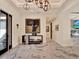 Elegant foyer featuring marble floors, modern lighting, stylish console table and seamless access to other rooms at 9364 Thurloe Pl, Orlando, FL 32827