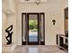 Elegant foyer featuring marble flooring, modern light fixtures, and a view of the meticulously landscaped front yard at 9364 Thurloe Pl, Orlando, FL 32827