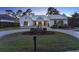 Charming front exterior with well-manicured lawn, circular driveway, and inviting entrance at 9364 Thurloe Pl, Orlando, FL 32827