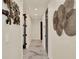 Elegant hallway with marble floors, modern lighting and sophisticated wall art at 9364 Thurloe Pl, Orlando, FL 32827