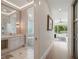 Bright hallway leading to a modern bathroom with luxurious fixtures and finishes at 9364 Thurloe Pl, Orlando, FL 32827
