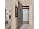 Wide hallway connecting the bedroom and bathroom, with marble floors and an open door to an elevator at 9364 Thurloe Pl, Orlando, FL 32827
