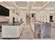 Open concept kitchen featuring islands, marble floors, and coffered ceilings at 9364 Thurloe Pl, Orlando, FL 32827