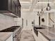 Modern kitchen with stainless steel appliances, kitchen island, and marble countertops and backsplash at 9364 Thurloe Pl, Orlando, FL 32827