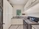 Well-organized laundry room with modern appliances, ample storage, and granite countertops at 9364 Thurloe Pl, Orlando, FL 32827