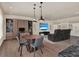 Living room showcasing theater seating, a gaming table, a large TV, and hardwood floors at 9364 Thurloe Pl, Orlando, FL 32827
