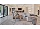 Open-concept living room showcasing marble floors, recessed lighting, and a comfortable white sofa at 9364 Thurloe Pl, Orlando, FL 32827