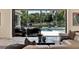 Living room view through sliding glass doors to an outdoor seating area and swimming pool at 9364 Thurloe Pl, Orlando, FL 32827