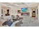 Bright living room featuring a coffered ceiling, fireplace, and comfortable white sofa at 9364 Thurloe Pl, Orlando, FL 32827