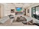 Bright living room with marble floors, fireplace, TV and sliding doors to an outdoor living space at 9364 Thurloe Pl, Orlando, FL 32827