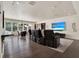 A spacious living room with theater seating, recessed lighting, a gaming table, and hardwood floors at 9364 Thurloe Pl, Orlando, FL 32827