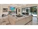 Living room with fireplace, marble floors, and sliding glass doors opening to a covered patio and pool at 9364 Thurloe Pl, Orlando, FL 32827