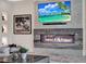 Living room featuring a modern fireplace, large-screen TV, and stylish decor at 9364 Thurloe Pl, Orlando, FL 32827