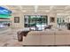 Open-concept living room with coffered ceiling, marble floors, fireplace, and access to the pool area at 9364 Thurloe Pl, Orlando, FL 32827