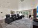 Living room boasting theater seating, a large window, a gaming table, and recessed lighting at 9364 Thurloe Pl, Orlando, FL 32827