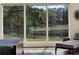 Bedroom sitting area with view of the lake and manicured backyard at 9364 Thurloe Pl, Orlando, FL 32827