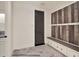 Well-designed mudroom featuring a built-in bench, storage drawers, and convenient coat hooks at 9364 Thurloe Pl, Orlando, FL 32827