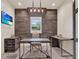 Home office with custom wood accent wall and marble floors offering a productive workspace at 9364 Thurloe Pl, Orlando, FL 32827