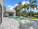 Stunning pool with a tranquil lake view, surrounded by well-manicured landscaping at 9364 Thurloe Pl, Orlando, FL 32827