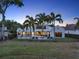 Beautiful rear view of home showcases a fenced yard, swimming pool, and lush landscaping at 9364 Thurloe Pl, Orlando, FL 32827