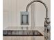 Close up of a chrome finished faucet and dark marble countertop in a home sink at 9364 Thurloe Pl, Orlando, FL 32827