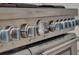 Close up of high end stainless steel stove with multiple knobs and gauge at 9364 Thurloe Pl, Orlando, FL 32827