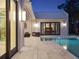 Inviting outdoor living area features a sparkling swimming pool with access to the main bedroom at 9364 Thurloe Pl, Orlando, FL 32827