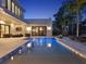 The backyard features a pristine swimming pool, lounge seating, and a modern outdoor entertainment area at 9364 Thurloe Pl, Orlando, FL 32827