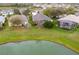 Aerial view of home and surrounding yard bordering pond at 10414 Andover Point Cir, Orlando, FL 32825