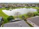 Aerial view of homes surrounding a picturesque pond at 10414 Andover Point Cir, Orlando, FL 32825