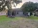 Green backyard with screened-in patio view at 10414 Andover Point Cir, Orlando, FL 32825